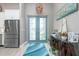Elegant foyer with a glass paneled door, stylish decor, and plenty of natural light at 13284 Amaryllis Cir, Port Charlotte, FL 33981