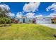 Well-manicured lawn and landscaping enhance the curb appeal of this home with a 3-car garage at 13284 Amaryllis Cir, Port Charlotte, FL 33981