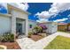 Stunning single-Gathering home featuring beautiful landscaping, a stone accent wall, and a charming entryway at 13284 Amaryllis Cir, Port Charlotte, FL 33981