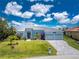Charming single-story home with a three-car garage, well-manicured lawn, and a lovely garden at 13284 Amaryllis Cir, Port Charlotte, FL 33981