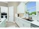 Well-equipped kitchen with stone countertops, white cabinetry, and modern appliances for culinary enthusiasts at 13284 Amaryllis Cir, Port Charlotte, FL 33981