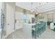 Bright kitchen with white cabinetry, marble countertop island with barstool seating, and decorative lighting at 13284 Amaryllis Cir, Port Charlotte, FL 33981