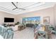 Open living room and dining area with coffered ceilings, ceiling fan, and a view of the outdoor patio at 13284 Amaryllis Cir, Port Charlotte, FL 33981