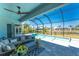 Inviting patio with screened-in lanai overlooking the pool and scenic view of the water at 13284 Amaryllis Cir, Port Charlotte, FL 33981