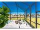 A covered lanai features outdoor seating, plants, and a serene view of the waterfront at 13284 Amaryllis Cir, Port Charlotte, FL 33981