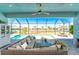 Relaxing screened patio with a comfortable seating area overlooking the sparkling pool and lush landscaping at 13284 Amaryllis Cir, Port Charlotte, FL 33981
