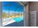 View of the screened-in pool and spa with lush landscaping and a waterfront view at 13284 Amaryllis Cir, Port Charlotte, FL 33981