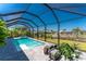 Lovely pool and spa with screened-in lanai overlooking mature landscaping, and lake at 13284 Amaryllis Cir, Port Charlotte, FL 33981
