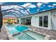 Beautiful pool and spa area with a screened enclosure providing a relaxing oasis and outdoor enjoyment at 13284 Amaryllis Cir, Port Charlotte, FL 33981
