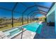 Inviting pool and spa with screened-in lanai overlooking a beautiful view of the lake at 13284 Amaryllis Cir, Port Charlotte, FL 33981