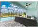 This screened-in pool area includes an outdoor lounge area and beautiful views of the lake at 13284 Amaryllis Cir, Port Charlotte, FL 33981