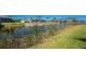 Beautiful waterfront property with lush green grass, landscaping and stunning water views at 13284 Amaryllis Cir, Port Charlotte, FL 33981