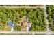 Aerial view of a beautiful property in a rural area, featuring a large house and a surrounding dense forest at 13325 Ketridge Ave, Port Charlotte, FL 33953