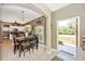 Open dining area features tile flooring and seamless access to the kitchen and a charming outdoor view at 13325 Ketridge Ave, Port Charlotte, FL 33953