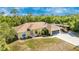 Beautiful single-story yellow home with RV parking, a long driveway, and colorful landscaping at 13325 Ketridge Ave, Port Charlotte, FL 33953