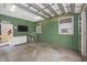 Finished garage space with painted block walls, a TV, and a mini fridge at 13325 Ketridge Ave, Port Charlotte, FL 33953