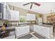 Well-lit kitchen showcases white cabinetry, stainless steel appliances, and a view into the dining area at 13325 Ketridge Ave, Port Charlotte, FL 33953