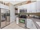 Spacious kitchen with stainless steel appliances and ample white cabinetry for storage and organization at 13325 Ketridge Ave, Port Charlotte, FL 33953