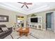 Bright living room featuring tile floors, a ceiling fan, and sliding glass doors to an outdoor space at 13325 Ketridge Ave, Port Charlotte, FL 33953