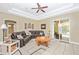 Spacious living room featuring a large sectional sofa, tile floors, and sliding door access to the lanai at 13325 Ketridge Ave, Port Charlotte, FL 33953