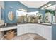 Large bathroom with double sinks, granite counters, ample storage, and glass-enclosed shower at 13325 Ketridge Ave, Port Charlotte, FL 33953