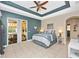 Inviting main bedroom with tray ceiling, fan, and sliding glass door to outdoor sitting area at 13325 Ketridge Ave, Port Charlotte, FL 33953