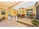 Inviting outdoor patio featuring a bar area, lounge seating, and a retractable awning at 13325 Ketridge Ave, Port Charlotte, FL 33953