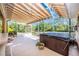 Covered patio area with a hot tub, bar seating, and a fully screened-in enclosure at 13325 Ketridge Ave, Port Charlotte, FL 33953