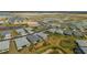 Discover a serene aerial view of a residential community featuring single-Gathering homes, tranquil lakes, and lush landscapes at 16440 Marsh Ln, Punta Gorda, FL 33982
