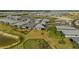 Enjoy the scenic aerial view of a peaceful neighborhood with single-Gathering homes, tranquil lakes, and lush greenery at 16440 Marsh Ln, Punta Gorda, FL 33982