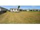 Enjoy the spacious backyard with lush green grass and views of neighboring homes, perfect for outdoor activities at 16440 Marsh Ln, Punta Gorda, FL 33982