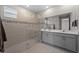 Beautiful bathroom with a glass-enclosed shower and double vanity with modern fixtures at 16440 Marsh Ln, Punta Gorda, FL 33982