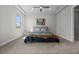 Bright bedroom featuring a ceiling fan, neutral walls, and a large window providing plenty of natural light at 16440 Marsh Ln, Punta Gorda, FL 33982