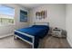 Modern bedroom with a platform bed, stylish art, and a large window providing ample natural light at 16440 Marsh Ln, Punta Gorda, FL 33982