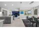 Bright open-concept dining area featuring modern lighting and seamlessly flowing into the kitchen and living spaces at 16440 Marsh Ln, Punta Gorda, FL 33982