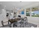Contemporary dining area featuring a modern light fixture and a seamless flow to the kitchen and living room at 16440 Marsh Ln, Punta Gorda, FL 33982
