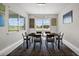 Bright dining room with a modern chandelier, seating for six, and large windows for lots of natural light at 16440 Marsh Ln, Punta Gorda, FL 33982