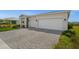 A well-designed driveway leads to a home with a two-car garage, framed by manicured landscaping at 16440 Marsh Ln, Punta Gorda, FL 33982