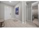 Welcoming foyer with tile flooring, contemporary artwork, and access to other rooms at 16440 Marsh Ln, Punta Gorda, FL 33982