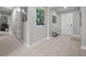 Inviting hallway with neutral walls, tile floors, and decorative wall art adds a touch of sophistication to the entrance at 16440 Marsh Ln, Punta Gorda, FL 33982
