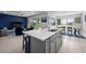 Open-concept kitchen with a large island, seamlessly connecting to the living and dining areas for entertaining at 16440 Marsh Ln, Punta Gorda, FL 33982