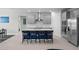 Modern kitchen featuring a central island with seating, stainless steel appliances, and sleek gray cabinetry at 16440 Marsh Ln, Punta Gorda, FL 33982