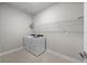 Practical laundry room with modern washer and dryer, plus a convenient shelf for storing supplies at 16440 Marsh Ln, Punta Gorda, FL 33982