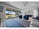 Spacious living room with an open floor plan, fan, and sliding glass doors to the backyard at 16440 Marsh Ln, Punta Gorda, FL 33982