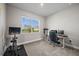 Bright office with a large window, modern desk setup, and exercise equipment at 16440 Marsh Ln, Punta Gorda, FL 33982
