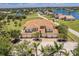 Beautiful aerial view of home with a tile roof, garages, and peaceful community lake at 16572 San Edmundo Rd # 111, Punta Gorda, FL 33955