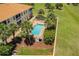 Aerial view showcases the inviting pool and spa area nestled within lush landscaping, a true oasis at 16572 San Edmundo Rd # 111, Punta Gorda, FL 33955
