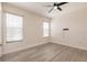 Bright bedroom with two windows and light wood-look flooring at 16572 San Edmundo Rd # 111, Punta Gorda, FL 33955