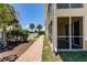The property features a well-manicured lawn, lush landscaping, and a charming screened lanai at 16572 San Edmundo Rd # 111, Punta Gorda, FL 33955
