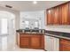 Kitchen featuring sleek countertops, stainless steel appliances, and wood cabinets at 16572 San Edmundo Rd # 111, Punta Gorda, FL 33955